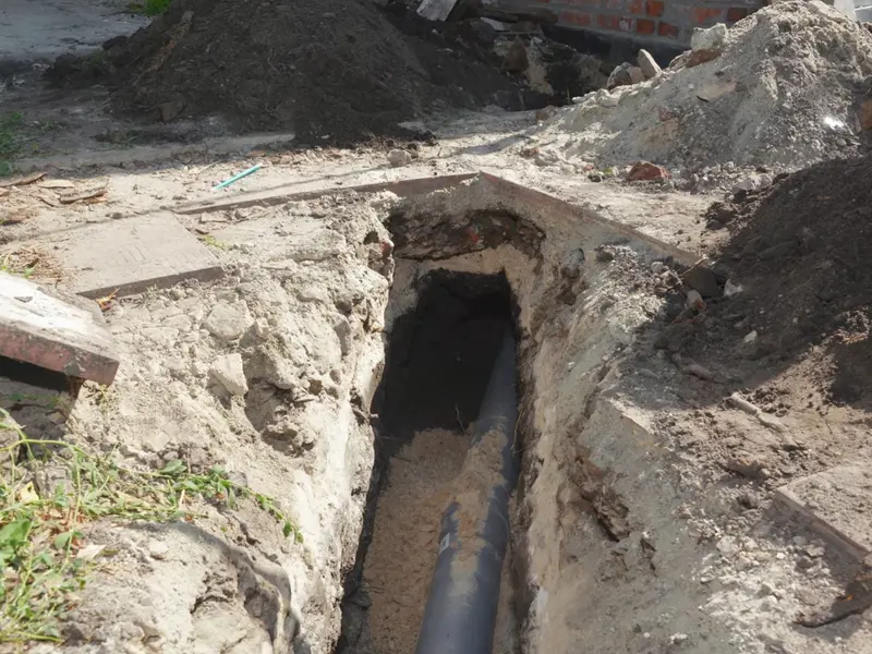 Open trench with new sewer or water line pipe for a plumbing service page in Hummelstown, PA