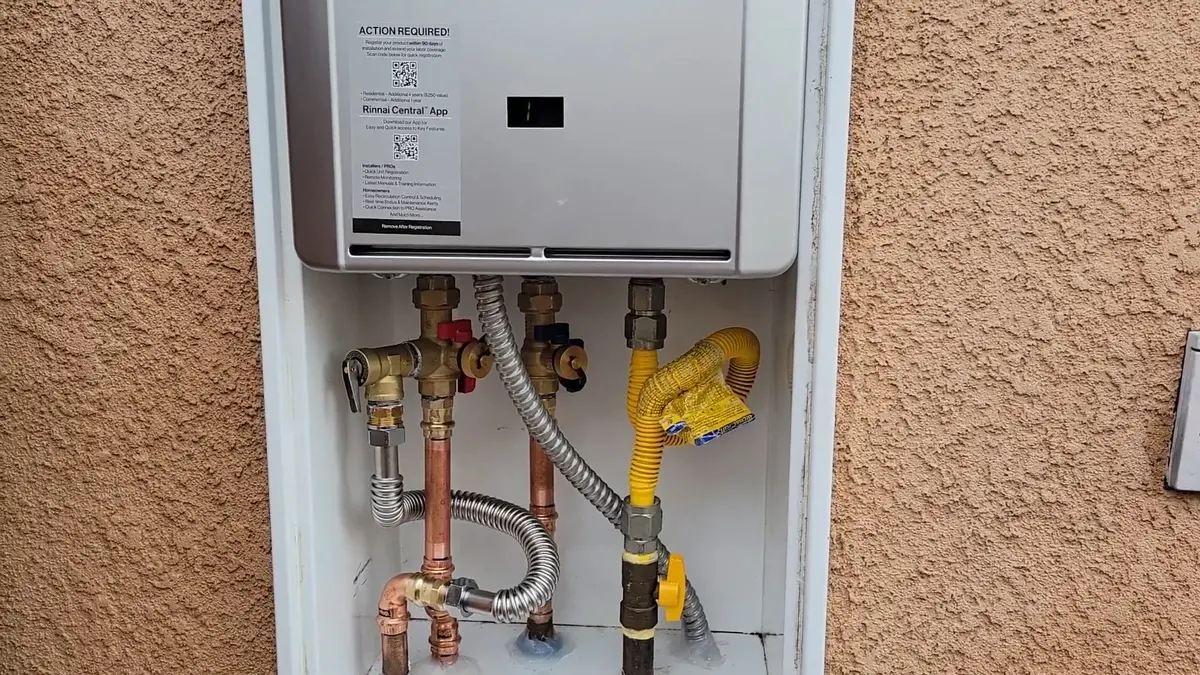 Tankless water heater with connected service piping illustrating Plumbing Tips for Older Lebanon Homes
